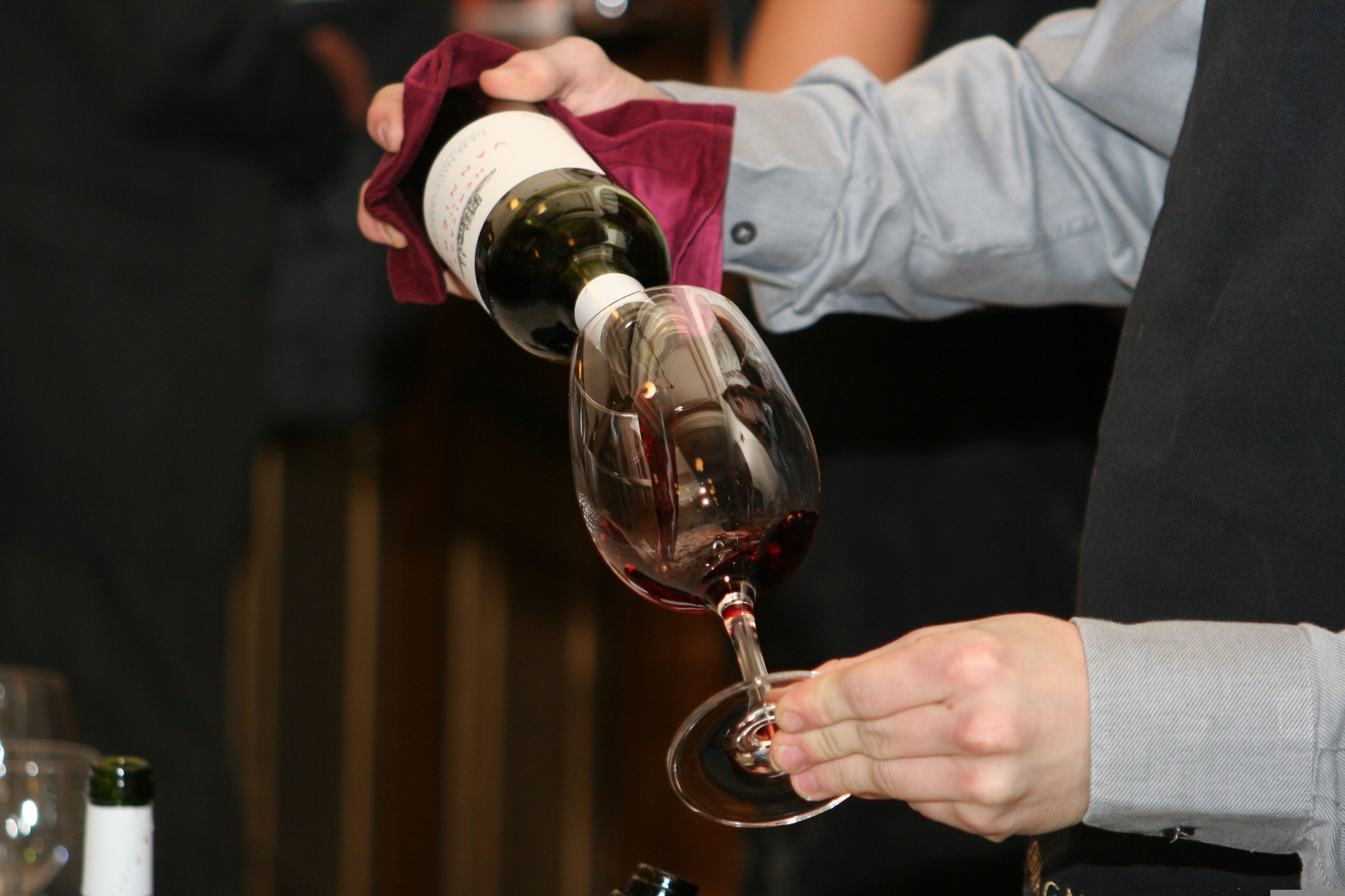 Red wine being poured into a glass during a bodega tasting, reflecting the wine experiences available around Murcia.
